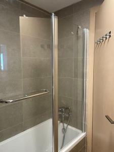 a bathroom with a shower with a glass door at Blue Sea Angels - Luxury appartment Front Sea in Netanya