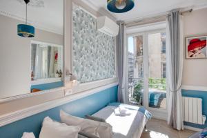 a room with a bed and a window at Marais Appart Haussmannien Neuf Clim & Ascenseur in Paris