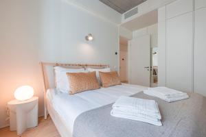a bedroom with a bed with towels on it at Deluxe 2BDR Apartment W/ Patio by LovelyStay in Lisbon