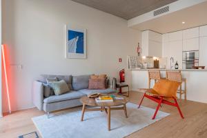 a living room with a couch and a table at Deluxe 2BDR Apartment W/ Patio by LovelyStay in Lisbon