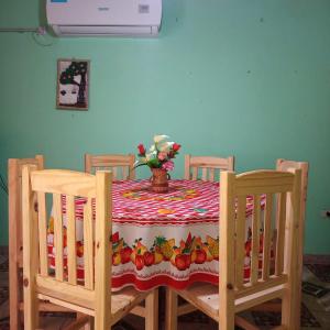 a dining room table with a vase of fruit on it at Cabaña Don Lorenzo in Puerto Victoria