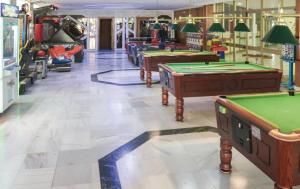 a row of pool tables in a billiard room at Apartamento con vistas al mar in Benalmádena