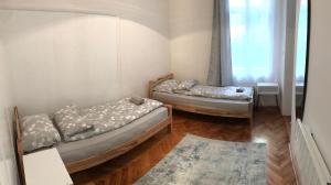 two beds in a room with a window at Apartment Amra in Sarajevo