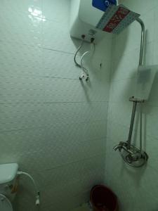 a small bathroom with a toilet and a shower at Dinero Crystal - 2 Bedroo, Apartment in Lagos
