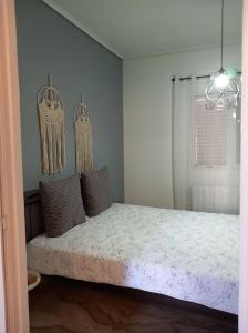 a bedroom with a bed with pillows on it at "Orpheus" - Kalamata Centre in Kalamata