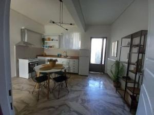 a kitchen with a table and chairs in a room at "Orpheus" - Kalamata Centre in Kalamata