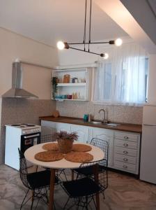 a kitchen with a table and chairs in a kitchen at "Orpheus" - Kalamata Centre in Kalamata