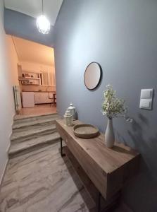 a living room with a table and a mirror at "Orpheus" - Kalamata Centre in Kalamata +2 photos