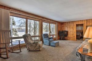 a living room with a couch and chairs and a television at Serene Woodruff Cottage Lakefront Access! in Woodruff