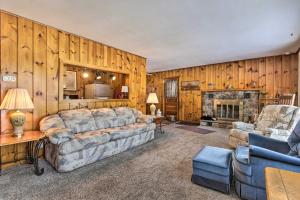 a living room with a couch and a fireplace at Serene Woodruff Cottage Lakefront Access! in Woodruff