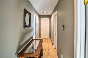 a hallway with a mirror on the wall at Cozy Southern Vermont Home with On-Site Trails in Whitingham