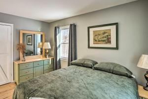 a bedroom with a bed and a dresser and a window at Cozy Southern Vermont Home with On-Site Trails in Whitingham
