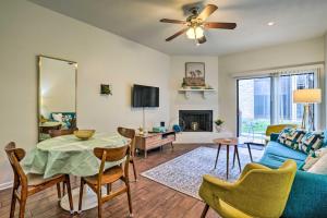 a living room with a blue couch and a table at Graham Haus River Condo Walk to Schlitterbahn! in New Braunfels