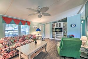 a living room with a couch and a table at Atlantic Beach Home with Decks and Fire Pit in Atlantic Beach