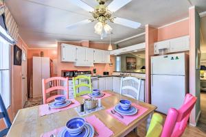 a kitchen with a table and chairs and a refrigerator at Atlantic Beach Home with Decks and Fire Pit in Atlantic Beach