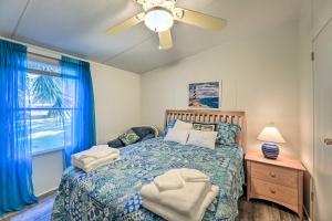 a bedroom with a bed and a ceiling fan at Atlantic Beach Home with Decks and Fire Pit in Atlantic Beach