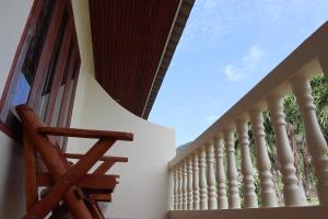 a staircase leading up to a house with white columns at The Green Koh Phangan in Haad Rin