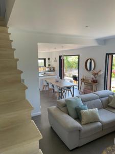 a living room with a couch and a dining room at Nid de rêves jacuzzi en Provence in Châteaurenard