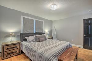 a bedroom with a bed and a table and a window at Modern Middletown Retreat, Minutes to Downtown! in Middletown