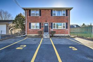 an empty parking lot in front of a brick building at Modern Middletown Retreat, Minutes to Downtown! in Middletown
