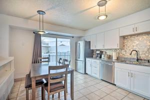 a kitchen with a table and chairs and a refrigerator at Millcreek Home with Mtn View Less Than 8 Mi to SLC! in Millcreek