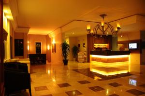 a lobby with a large lobby with a chandelier at Hisar Holiday Club in Oludeniz