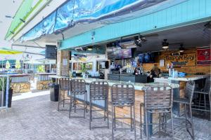 a bar with chairs sitting in front of a restaurant at All-New, Private, Huge TV, Heated Pool, Tiki Bar in Sarasota