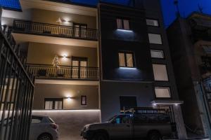 a car parked in front of a building at night at AN&VI Boutique Apartments Apt201 in Ioannina