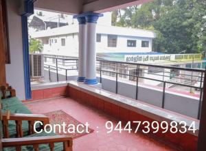 a balcony with a view of a swimming pool at Ritu Homestay (The Second Wind) in Trivandrum