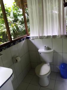 a bathroom with a toilet and a window at Inotawa Lodge in Tambopata