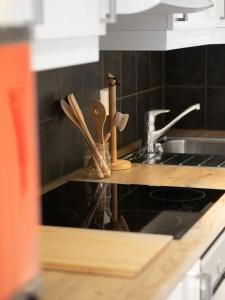 a kitchen counter with wooden utensils and a sink at Sentrumsvegen - Private Studio Apartment in Gol in Gol