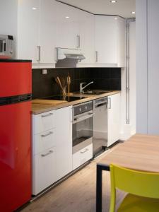 a kitchen with white cabinets and a wooden table at Sentrumsvegen - Private Studio Apartment in Gol in Gol