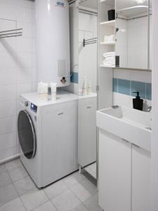 a white bathroom with a washing machine and a sink at Sentrumsvegen - Private Studio Apartment in Gol in Gol