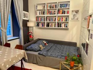 a bedroom with a bed and a book shelf at Feel at home - Self Check In in Vienna