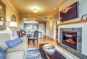 a living room with a couch and a fireplace at Chelan Resort Suites: Water Sunset (#303) in Chelan