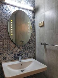 a bathroom with a sink and a mirror on the wall at Your ¥achting Home in Sousse
