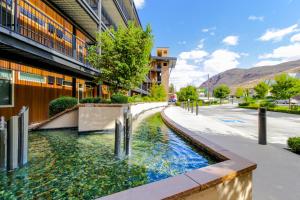 a pool of water next to a building at Chelan Resort Suites: Water Sunset (#303) in Chelan
