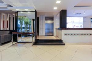 a lobby with a reception desk in a building at Sandri City Hotel in Balneário Camboriú