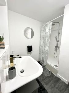 a white bathroom with a sink and a shower at Home in Levenshulme, Manchester in Manchester