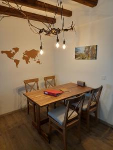 a dining room with a wooden table and chairs at Studio chez un vigneron au village in Villeneuve