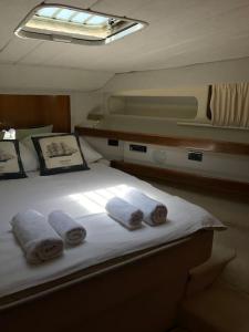 a bed on a boat with towels on it at Motor yacht 45', 3 Cabins, 2 WC in Aegina Town