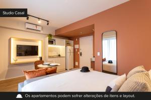 a room with a large bed and a living room at Charlie Aeroporto Congonhas CGH in Sao Paulo