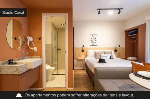 a hotel room with a bed and a bathroom at Charlie Aeroporto Congonhas CGH in Sao Paulo