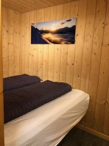 a bedroom with two beds in a wooden wall at Chalet Weidli in Achseten
