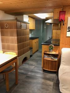 a large kitchen with a counter and a table in it at Chalet Weidli in Achseten