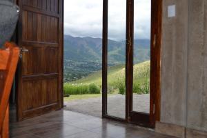 an open door with a view of a mountain at Aires del Alto - casas in Tafí del Valle