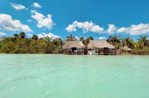 a resort on a tropical island in the water at Akalki Hotel y Centro Holistico in Bacalar