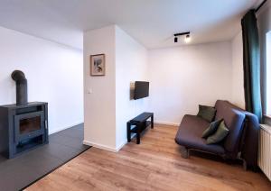 a living room with a chair and a fireplace at Apartmány Lučina in Veľký Slavkov