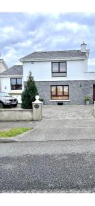 a house with a car parked in front of it at Forest Hills Lodge in Slane