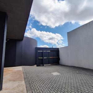 a building with a large garage door with a sky at Pousada Sol in Pato Branco